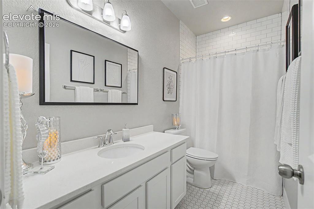 Image 32 of 40: The pristine full bath, next to the 4th bedroom, near the media area. Impre