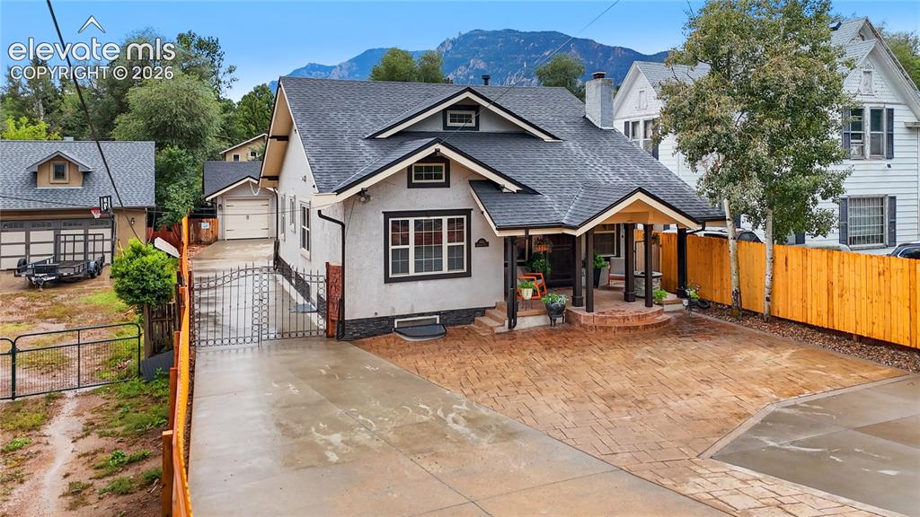 Image 10 of 45: Charming bungalow-style residence featuring a covered front porch with bric