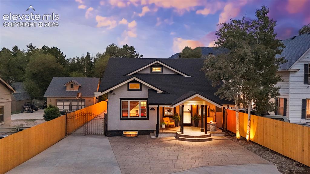 Image 2 of 45: Contemporary home with a stamped concrete driveway, covered porch entry, an