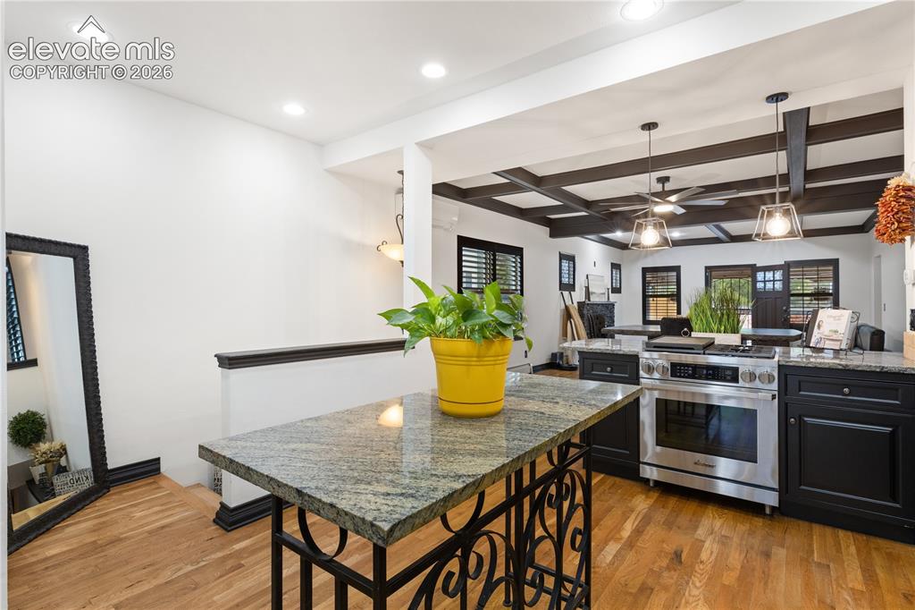 Image 25 of 45: Kitchen featuring black cabinetry, granite countertops, stainless steel ran
