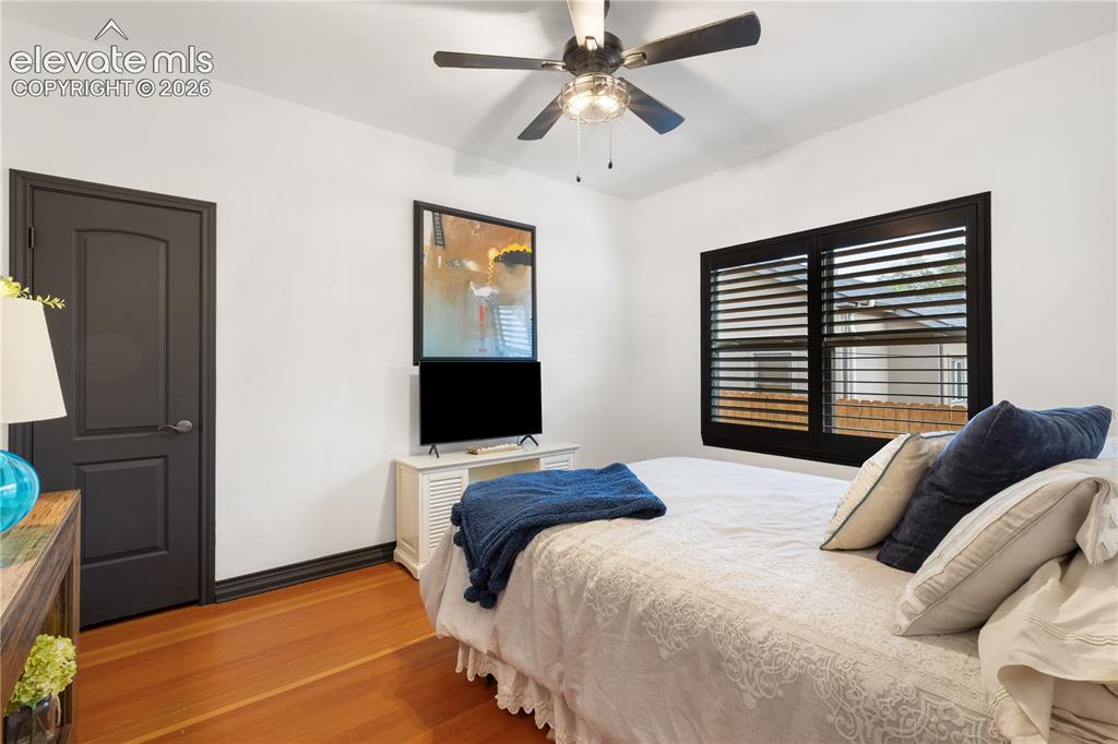 Image 36 of 45: Hardwood flooring complements a neutral wall color and dark trim