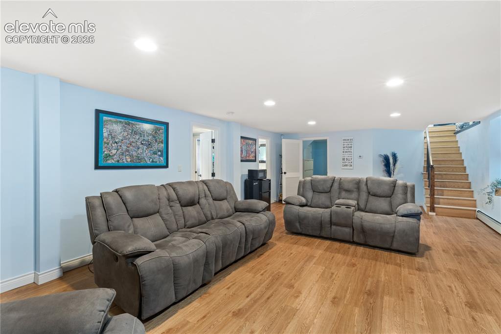 Image 38 of 45: Open-concept room featuring wood-finish flooring, light blue walls, and rec