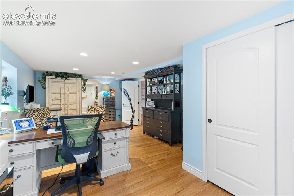Image 42 of 45: Versatile room featuring wood-finish flooring, recessed lighting, a built-i