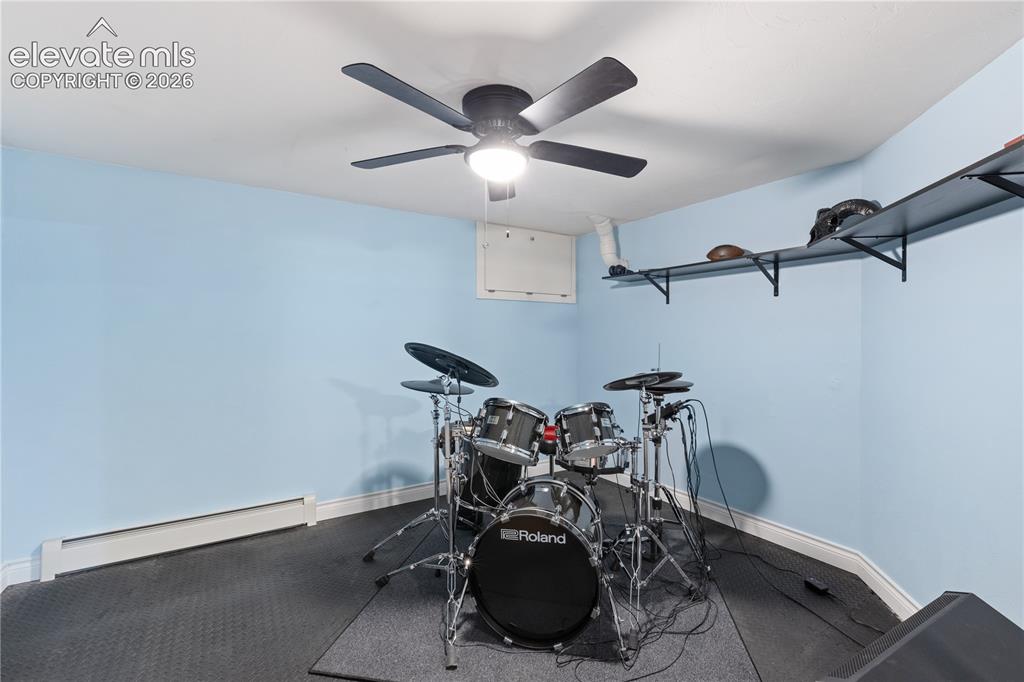 Image 44 of 45: Room featuring light blue walls, white trim, and dark textured flooring