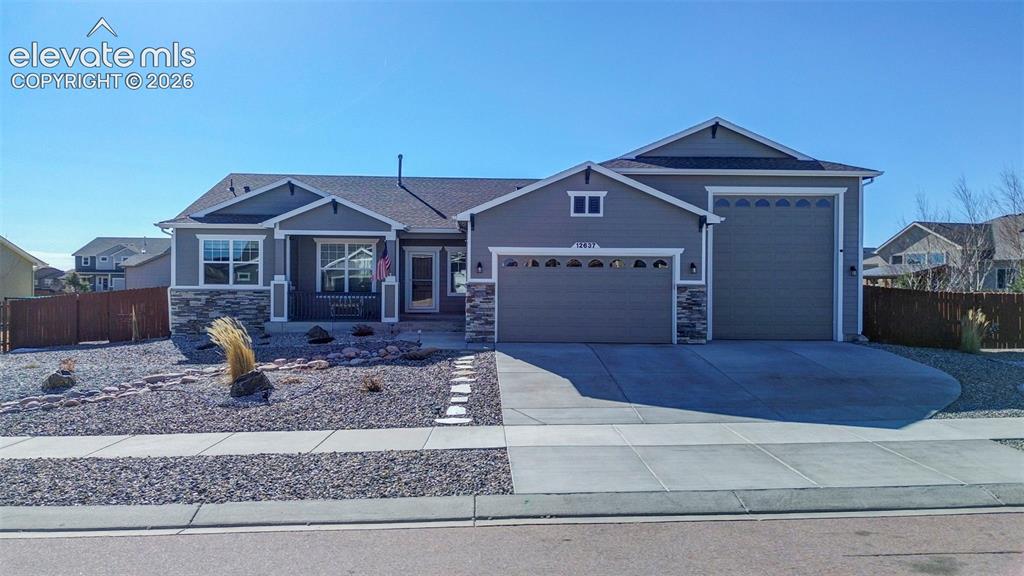 Image 1 of 48: Contemporary ranch-style residence featuring a prominent two-car garage and