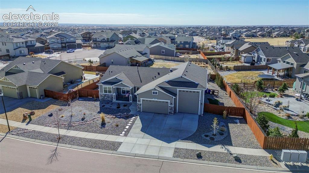 Image 2 of 48: Contemporary ranch-style residence featuring a prominent two-car garage, st