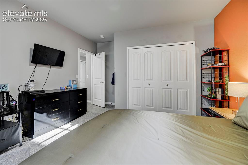 Image 30 of 48: Plush carpeting throughout with a two-panel bifold closet door, and a six-p