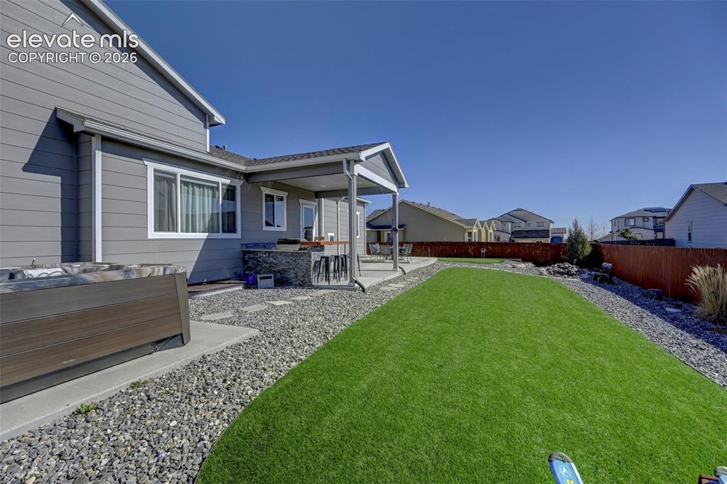 Image 5 of 48: Expansive backyard with artificial turf lawn