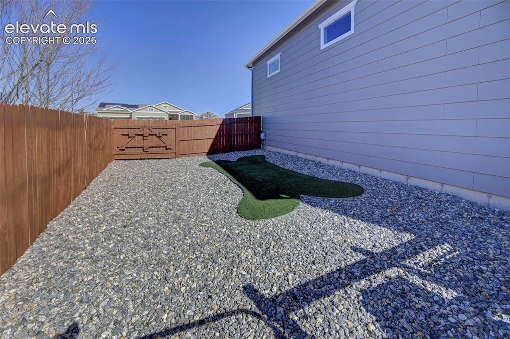 Image 9 of 48: Gravel ground cover with an artificial turf accent