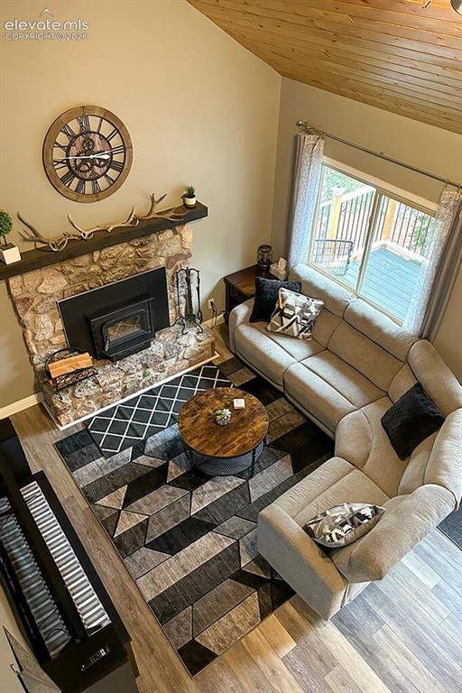 Image 12 of 32: Overlooking cozy family room with wood burning stove
