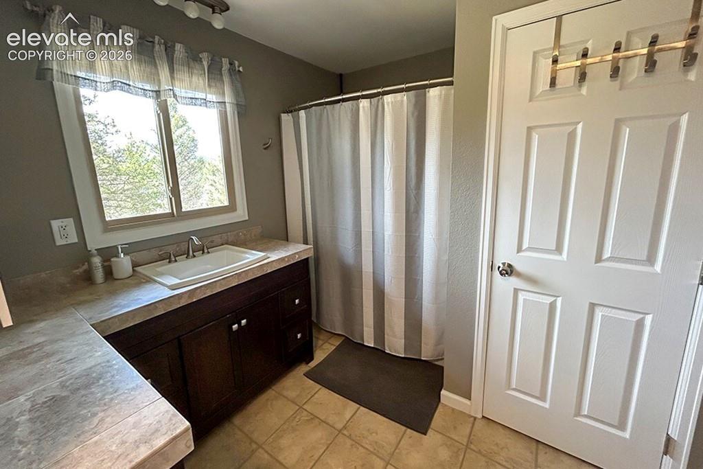Image 16 of 32: Full, oversized, main floor bathroom. Attached to large main floor bedroom