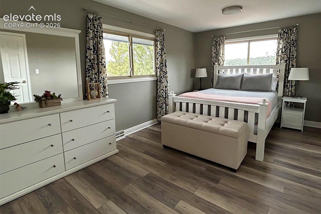 Image 19 of 32: Private primary bedroom with walk in closet, balcony and full, en suite bat