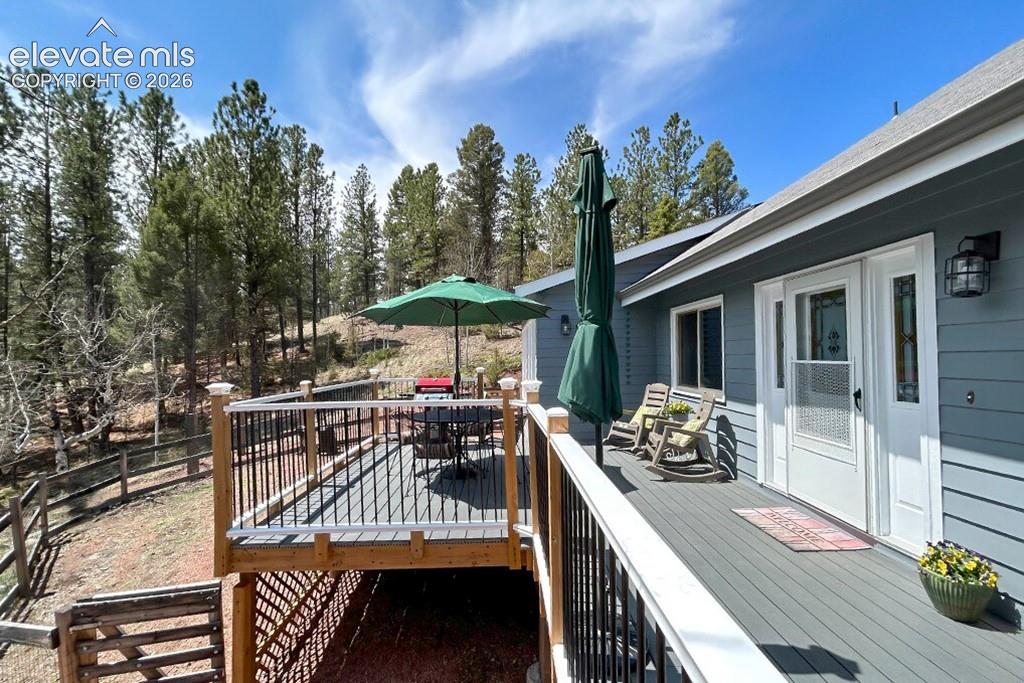 Image 3 of 32: Expansive deck featuring composite decking. Small fenced in area for pets.