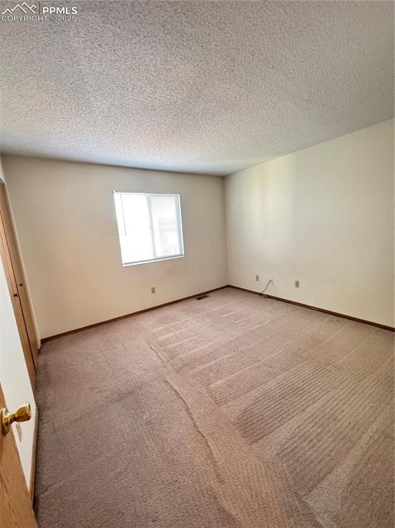Image 8 of 11: Unfurnished room featuring carpet flooring and a textured ceiling
