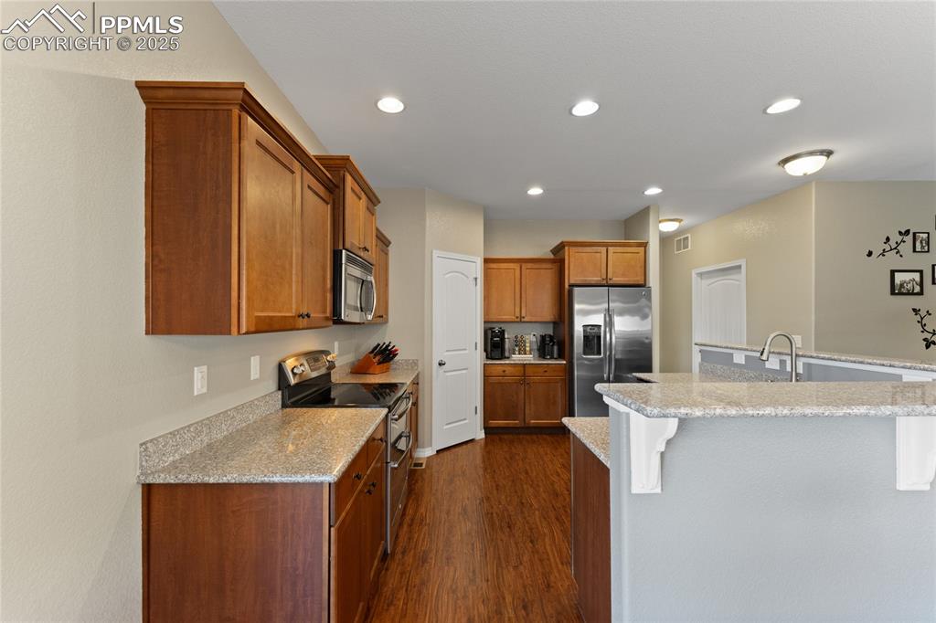 Image 12 of 41: Granite Counters and Stainless Appliances. Large Breakfast Bar
