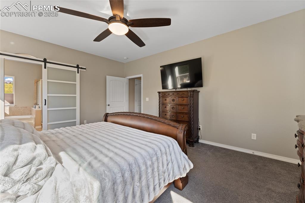 Image 16 of 41: Custom Barn Door leading to 5 Piece Bathroom