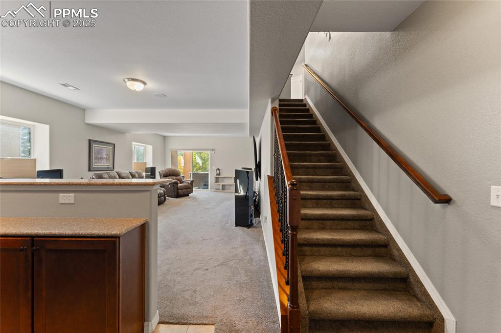Image 26 of 41: Giant family Room with Walkout to Patio. Large Wet Bar that is Great for En