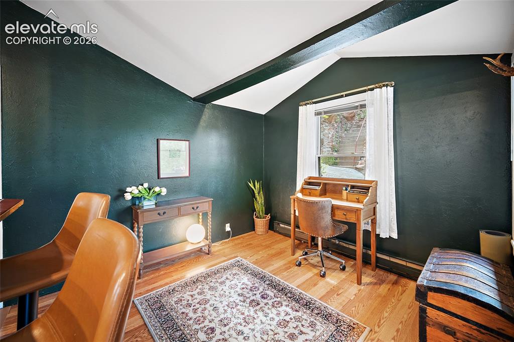 Image 11 of 31: Versatile home office or flex room with moody dark-green walls, hardwood fl