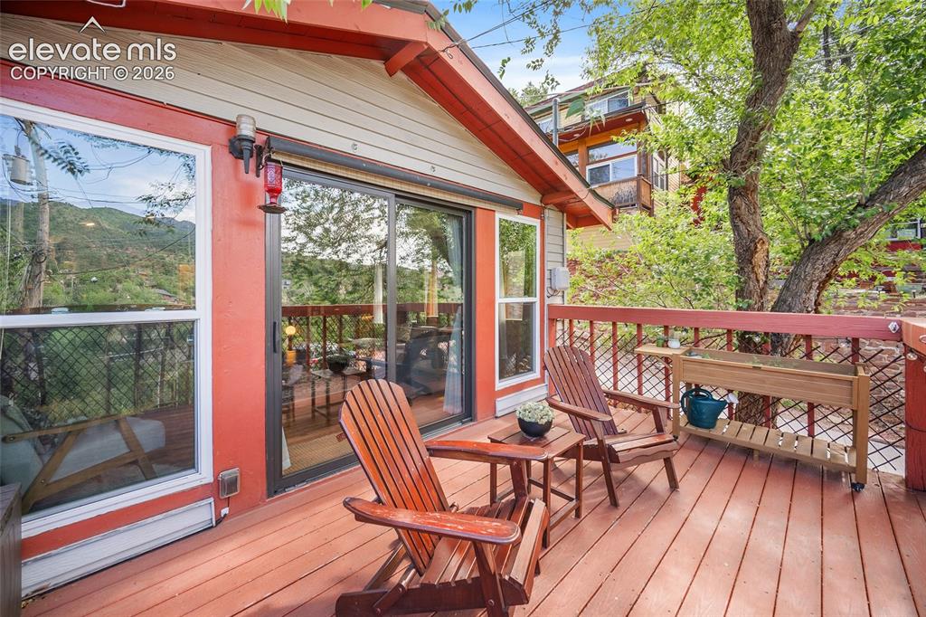 Image 14 of 31: Relaxing private deck wrapping the home, with comfortable seating, mature s