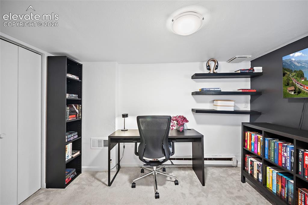 Image 18 of 31: Versatile lower-level room ideal as a home office, study, or guest bedroom,