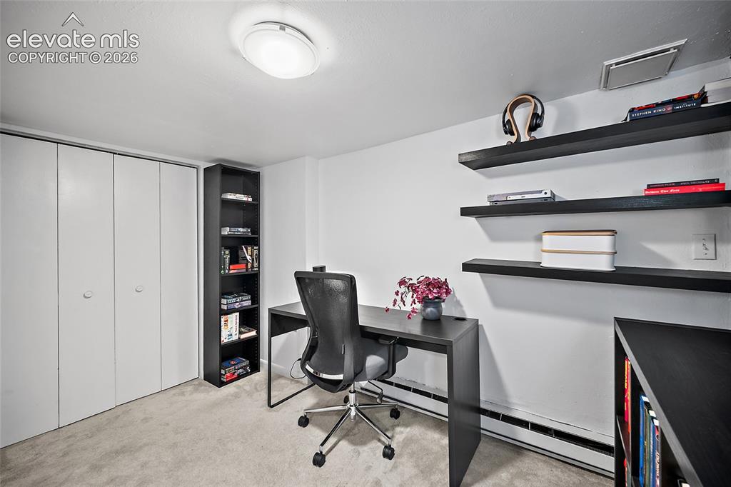 Image 20 of 31: Functional lower-level office showcasing generous built-in closet storage,