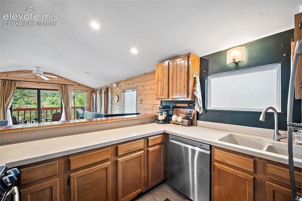 Image 8 of 31: Functional kitchen featuring solid-wood cabinetry, stainless steel applianc