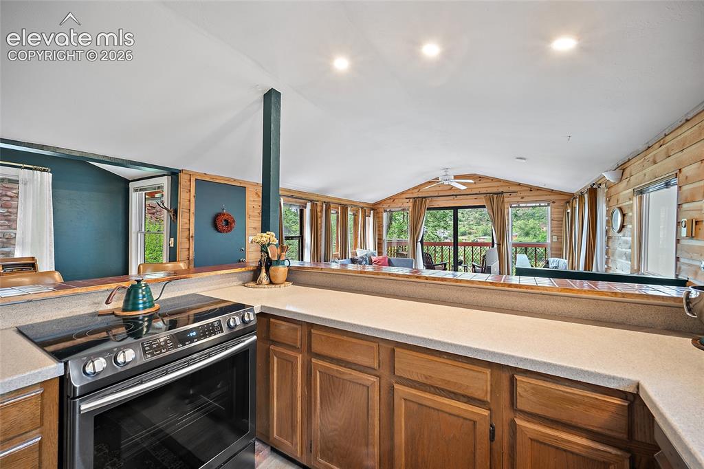 Image 9 of 31: Well-appointed kitchen with stainless range, oak cabinetry, and an open pas
