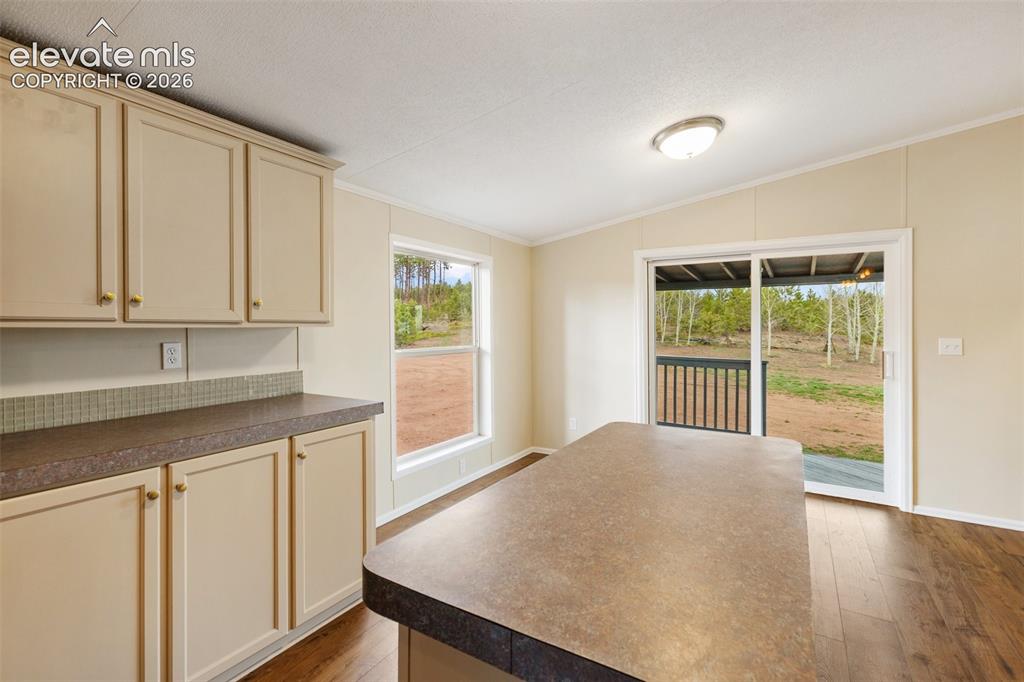 Image 22 of 48: Space for your dining table right there by that window in front of the slid