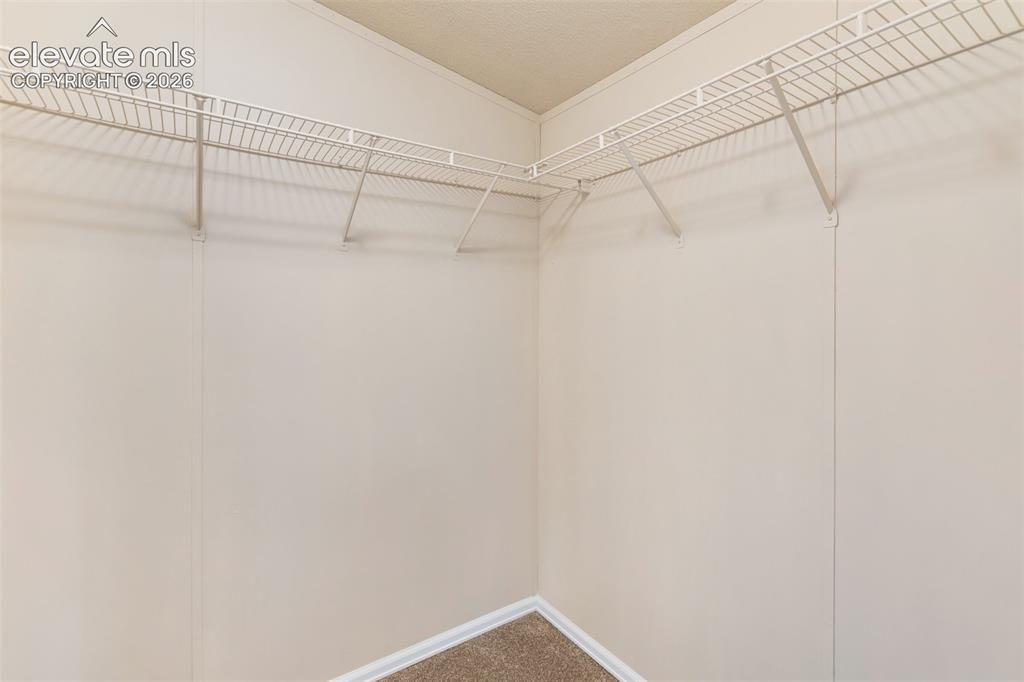 Image 30 of 48: Primary walk in closet