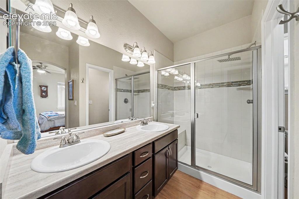 Image 13 of 26: Beautifully upgraded primary 3/4 bathroom with large shower with seat