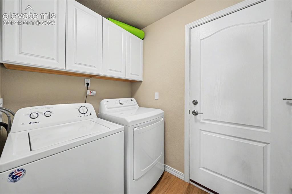 Image 14 of 26: Main level laundry with electric hook ups and door to garage