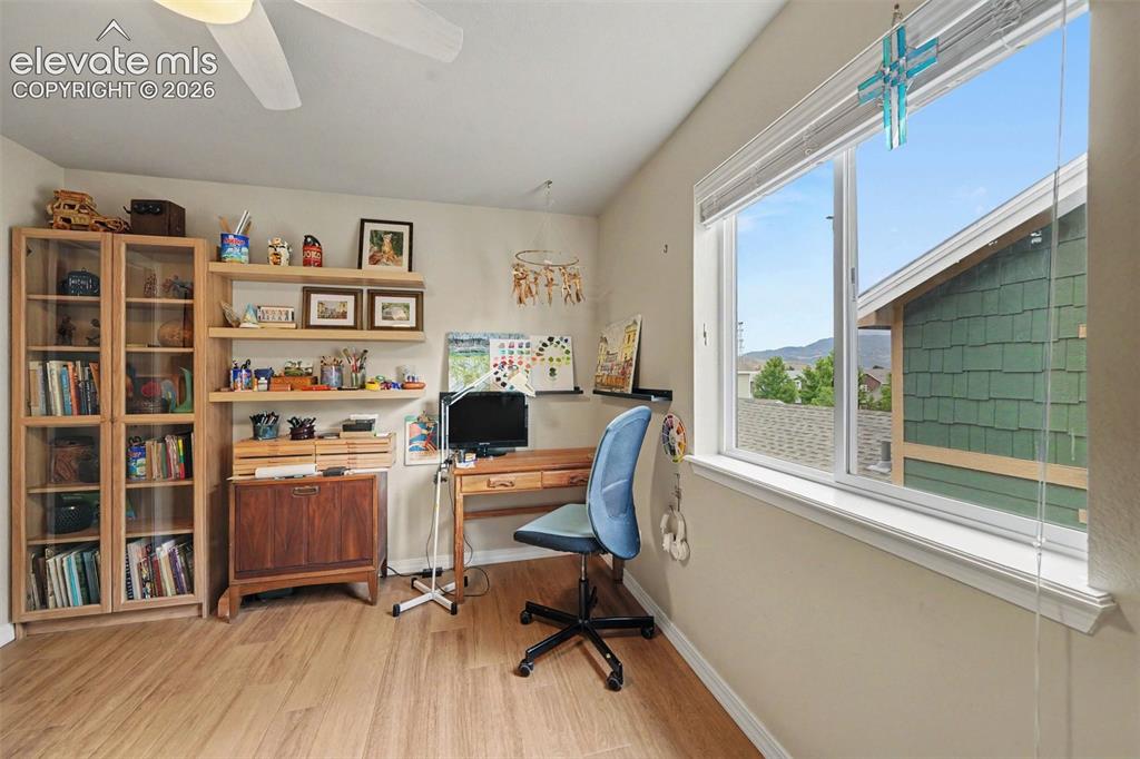 Image 17 of 26: A small view of mountains from this upper level bedroom 
