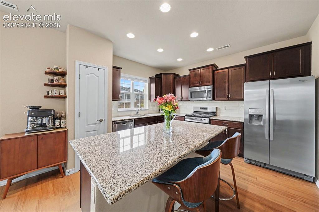 Image 8 of 26: Gorgeous upgraded kitchen with granite counters, cherry cabinets and stainl