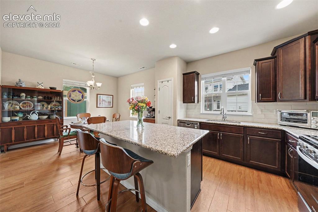 Image 9 of 26: Large kitchen with huge breakfast bar and dining area