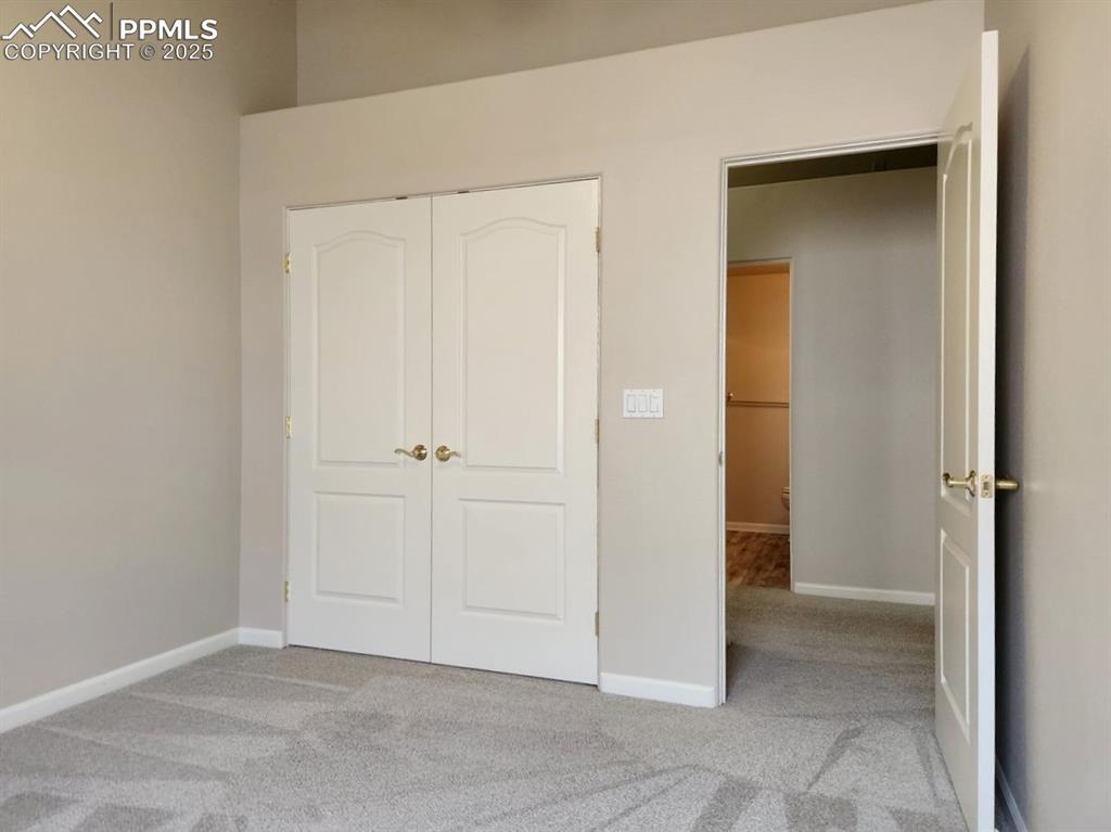 Image 20 of 34: Unfurnished bedroom featuring light carpet and a closet