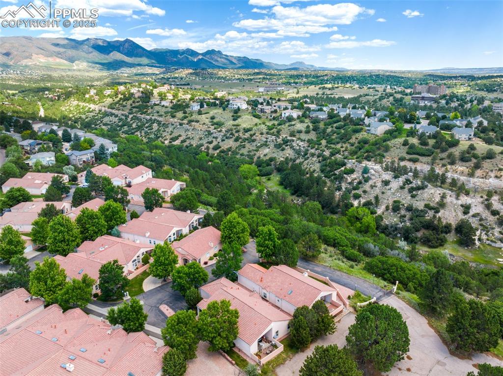 Image 26 of 34: Aerial perspective of suburban area featuring a mountain backdrop