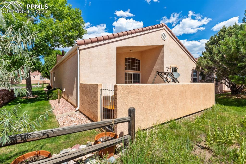 Image 33 of 34: View of side of home with stucco siding