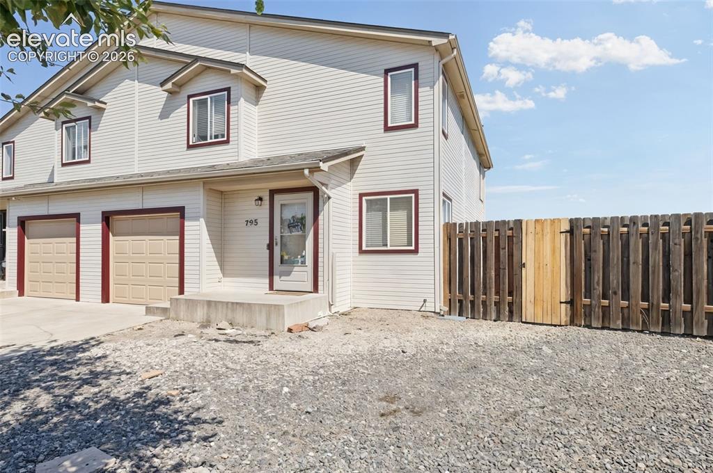 Caption: FRONT OF DUPLEX - EAST SIDE