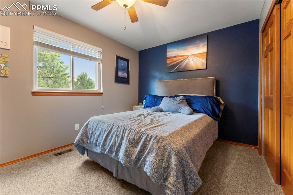 Image 30 of 50: Bedroom with carpet, ceiling fan, and a closet