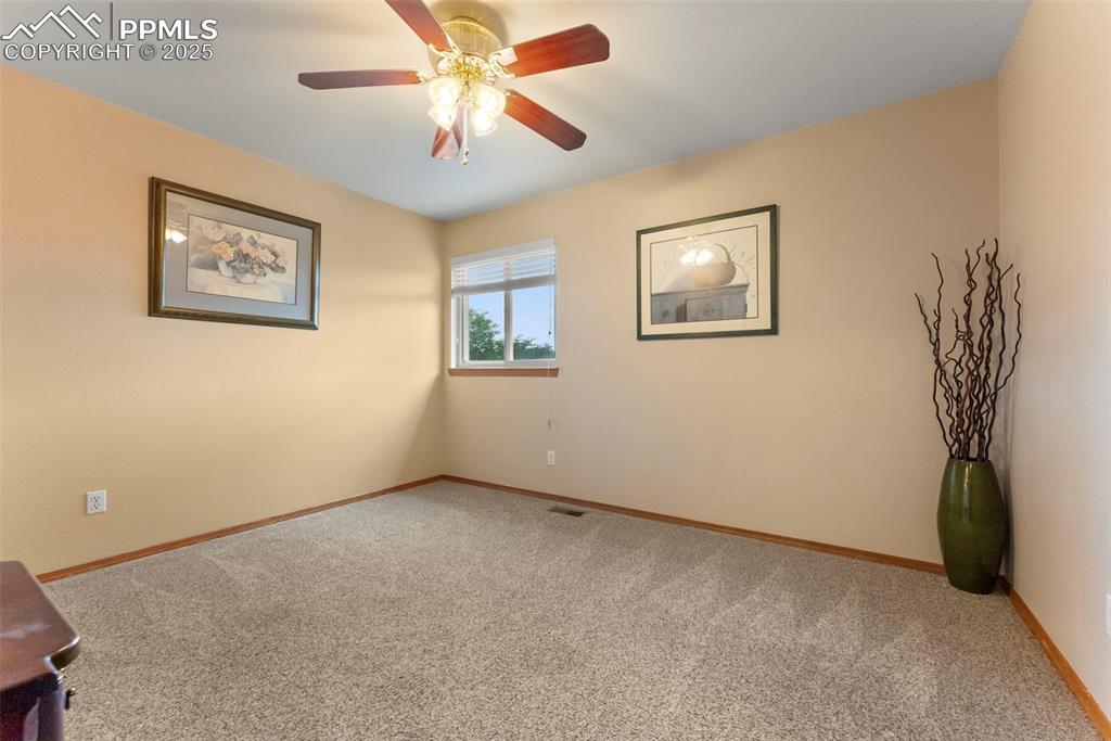 Image 32 of 50: Empty room featuring carpet flooring and ceiling fan