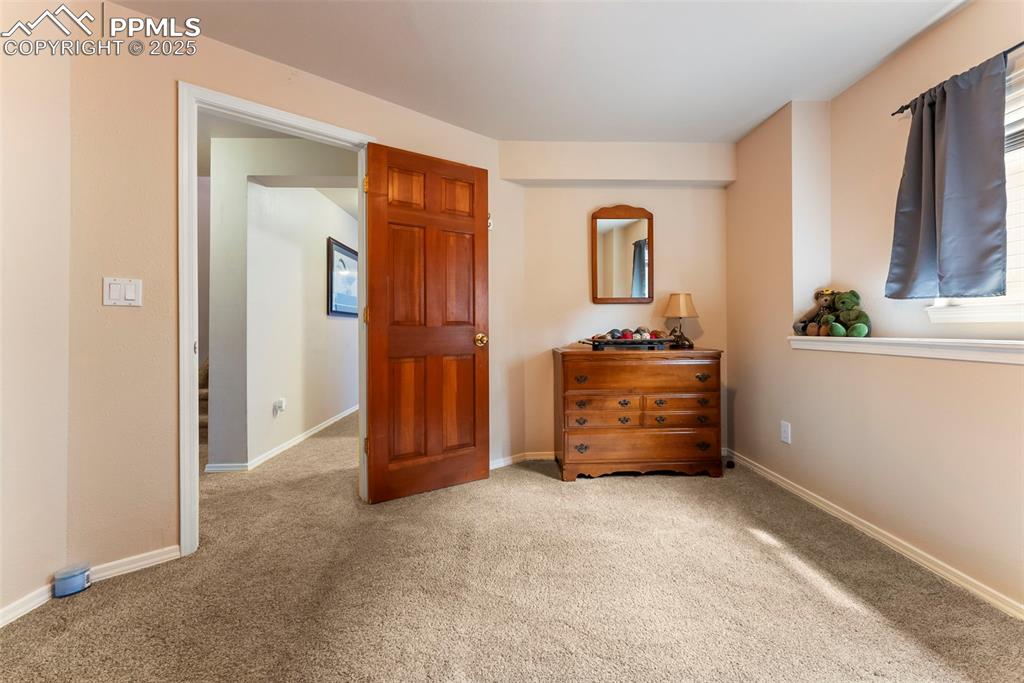 Image 36 of 50: Basement, Carpeted bedroom featuring baseboards