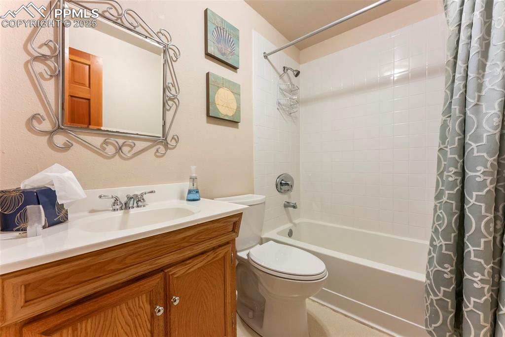 Image 37 of 50: Full bath with shower / tub combo and vanity