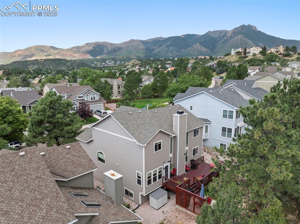 Image 46 of 50: Aerial view of residential area with a mountainous background