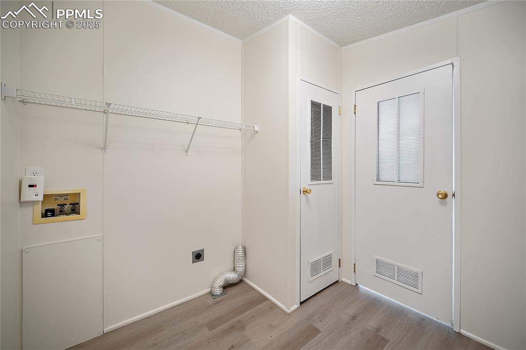 Image 14 of 34: Laundry/ mudroom with acces to the primary ensuite bath as well as kitchen 