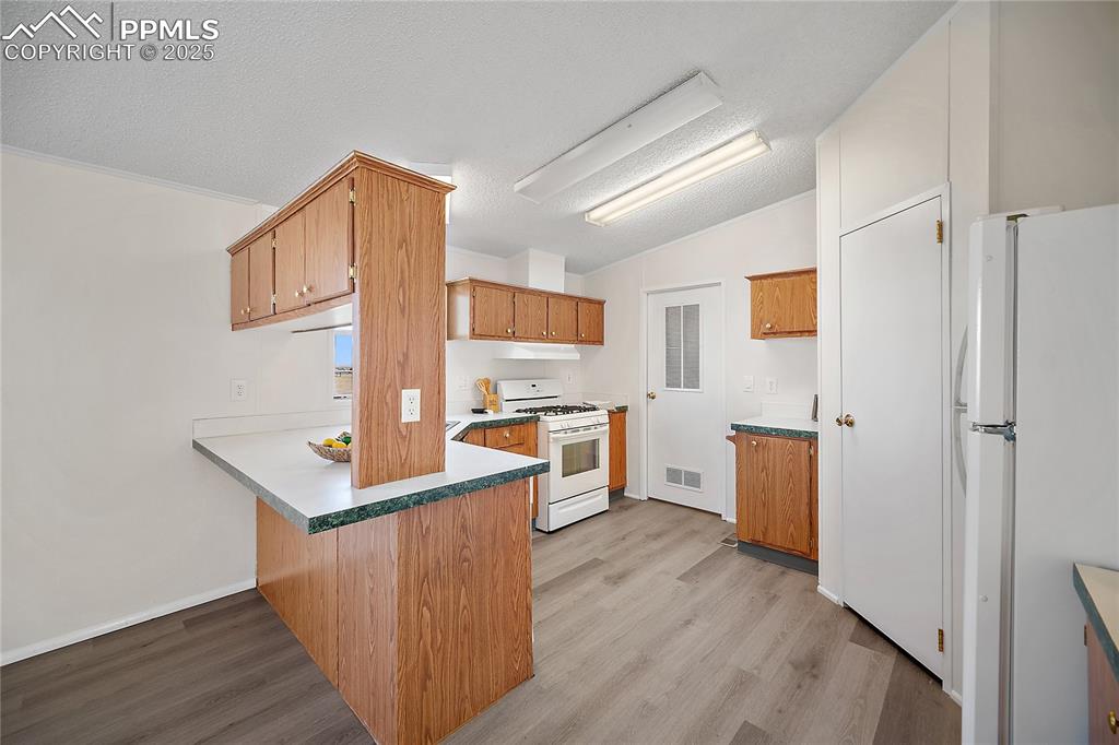 Image 17 of 34: Kitchen with breakfast bar and pantry. 