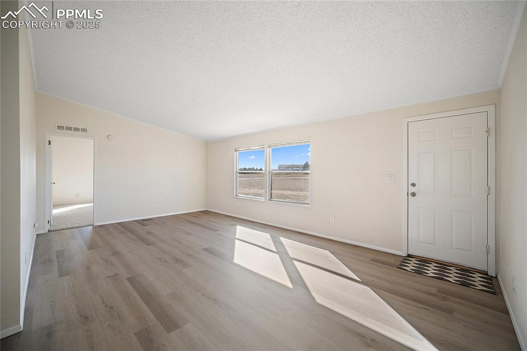 Image 7 of 34: Living room is open and bright. 