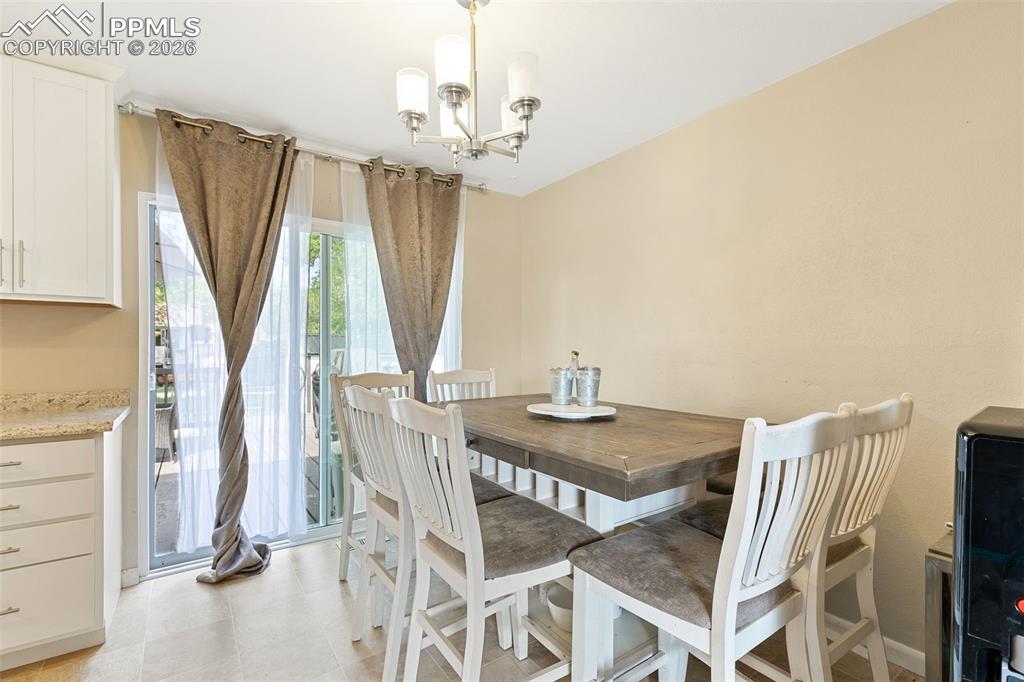 Image 11 of 38: Dining area featuring a chandelier