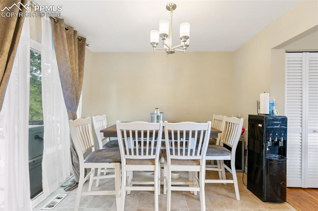 Image 12 of 38: Dining area with a chandelier