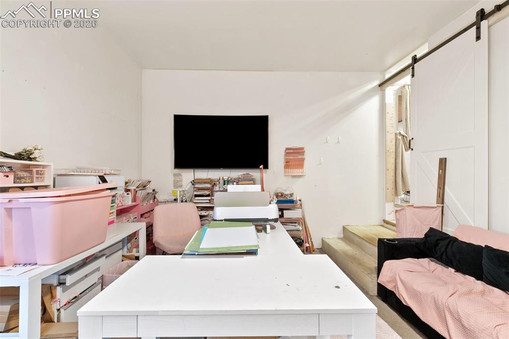 Image 18 of 38: Office area featuring a barn door