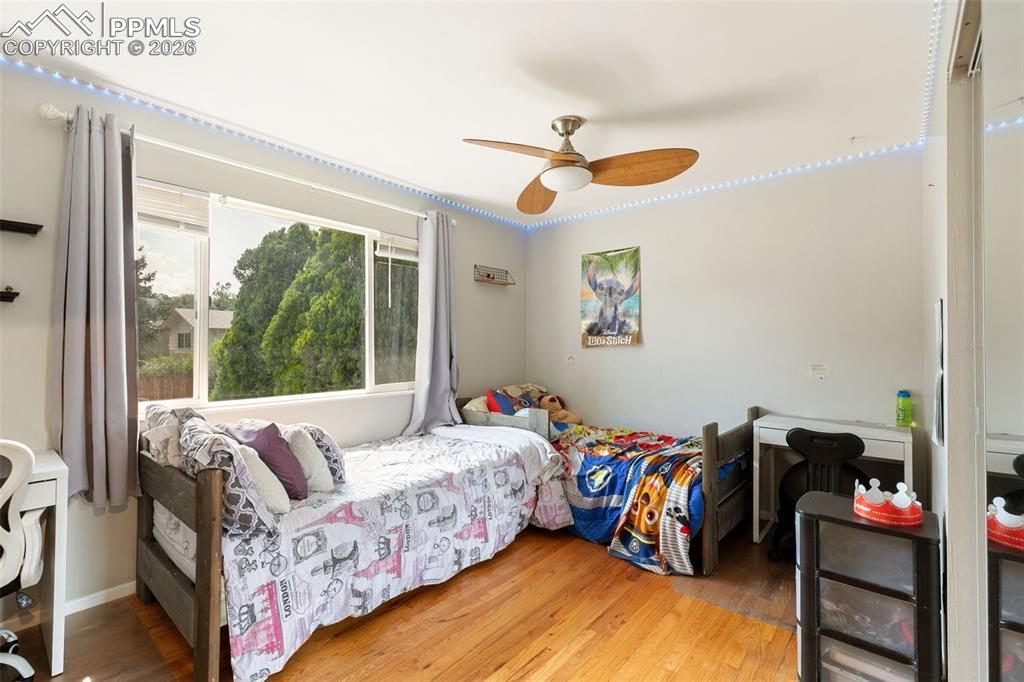 Image 20 of 38: Bedroom featuring wood finished floors and ceiling fan